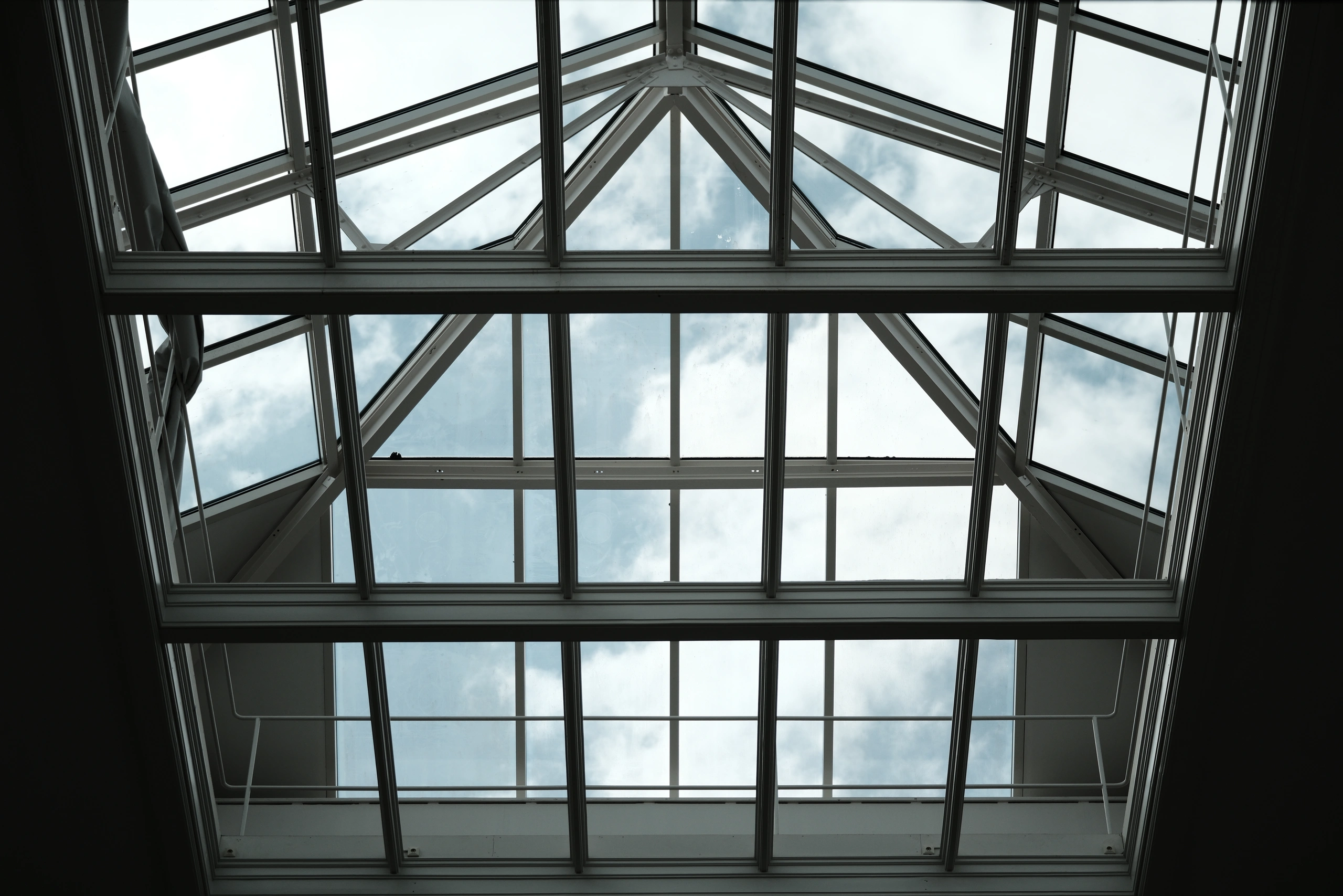 Symmetrical glass roof forming stacked triangular and rectangular shapes