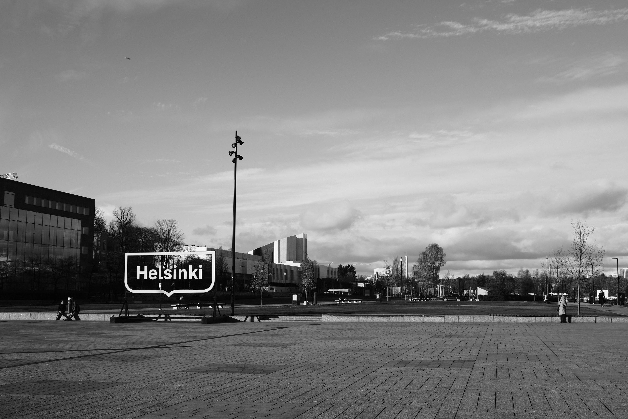 Helsinki sign beside an open waterfront square