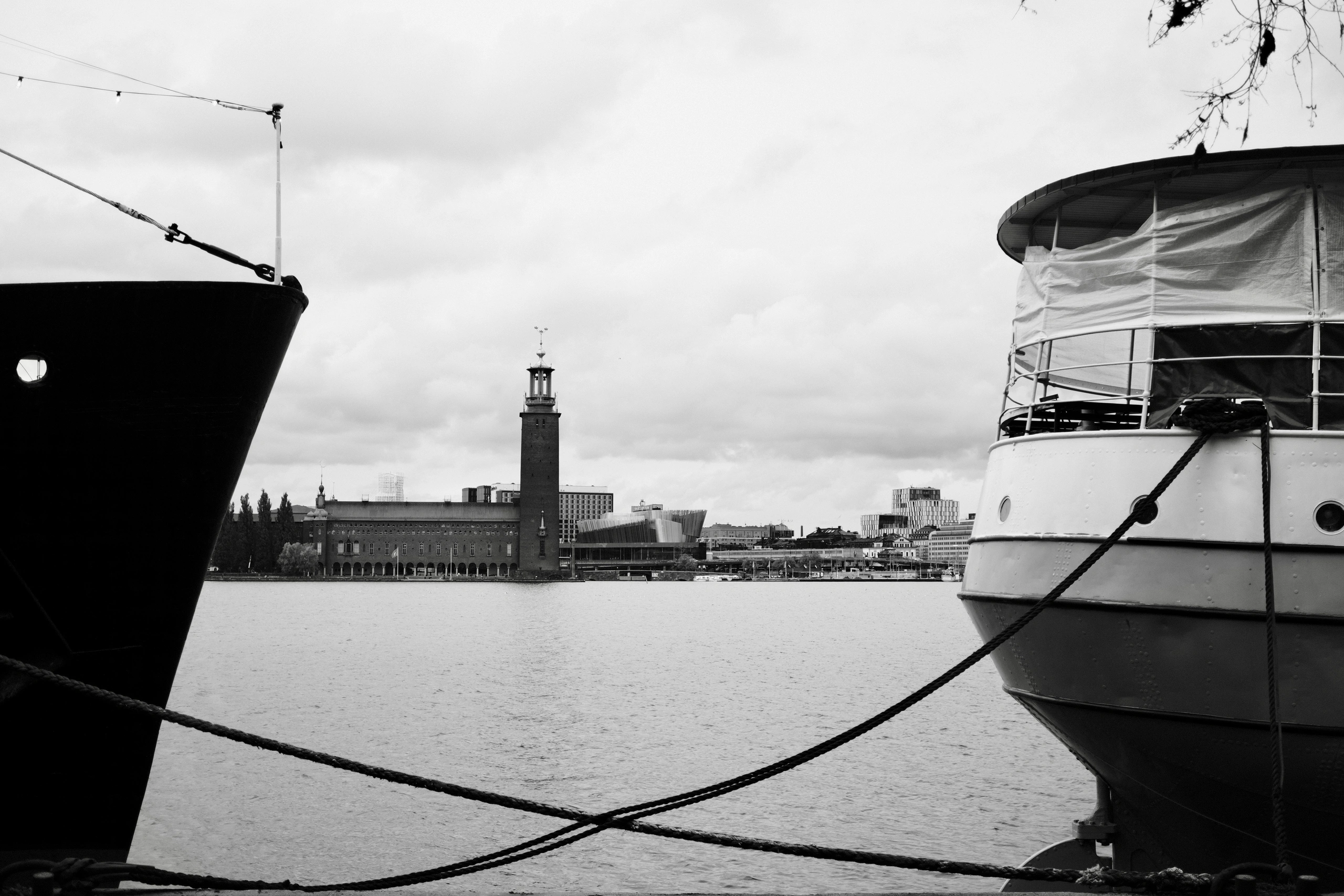 Stockholm City Hall across the water between two moored boats