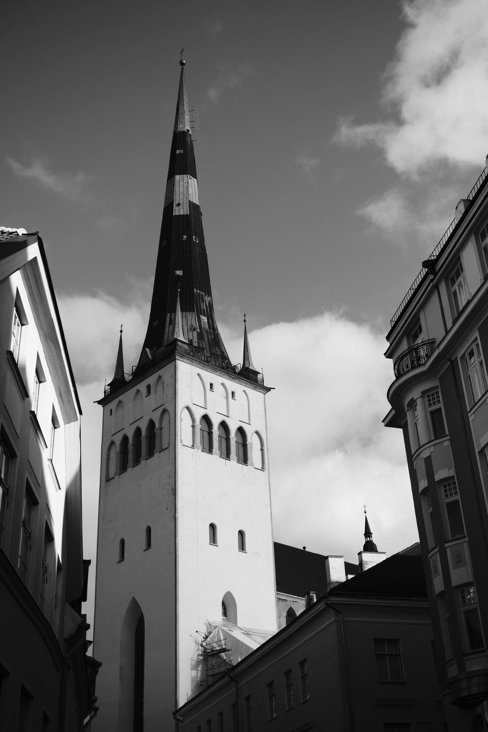 Tall church tower framed by old city buildings