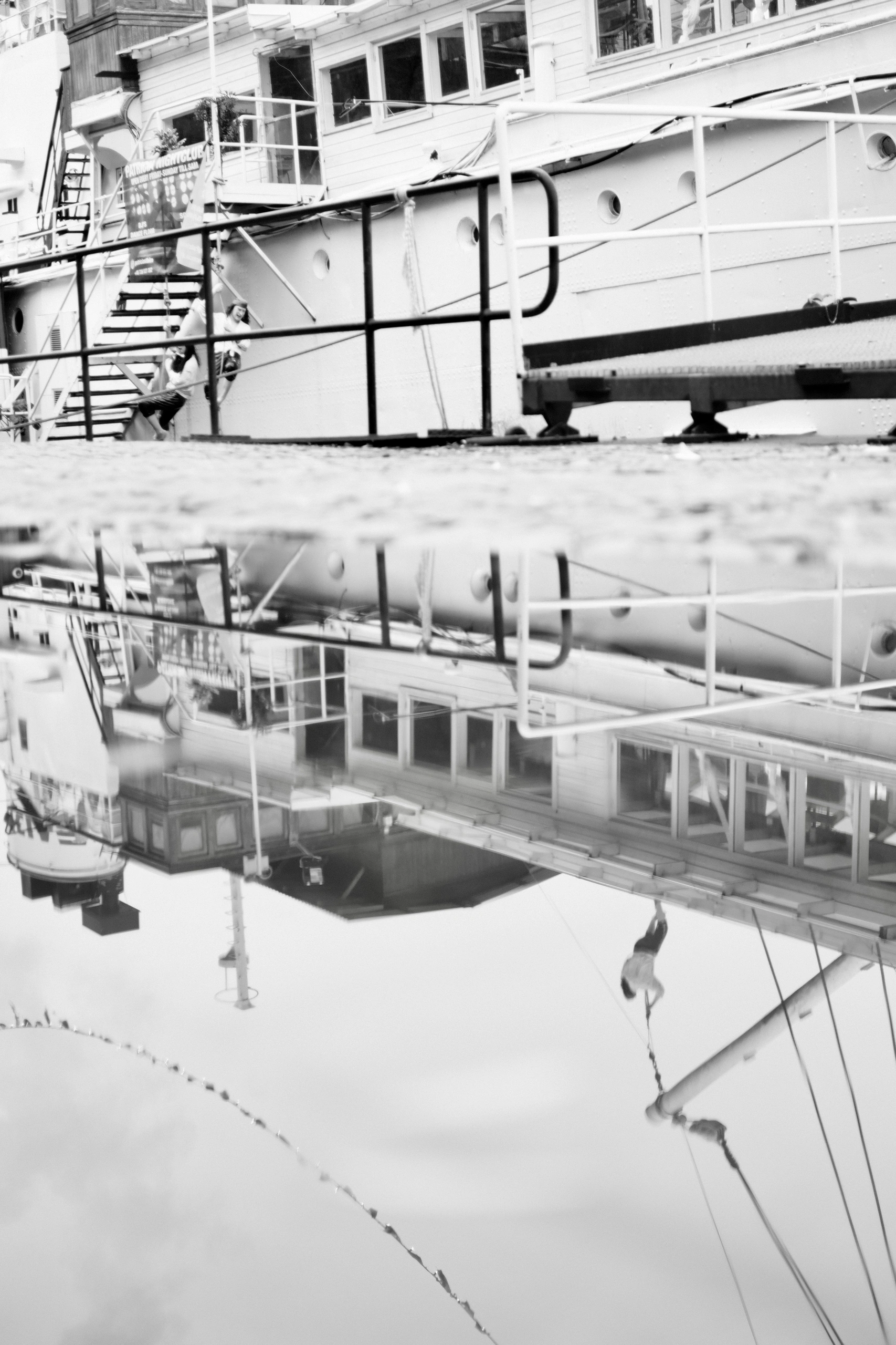 Moored boat and rigging reflected in still water