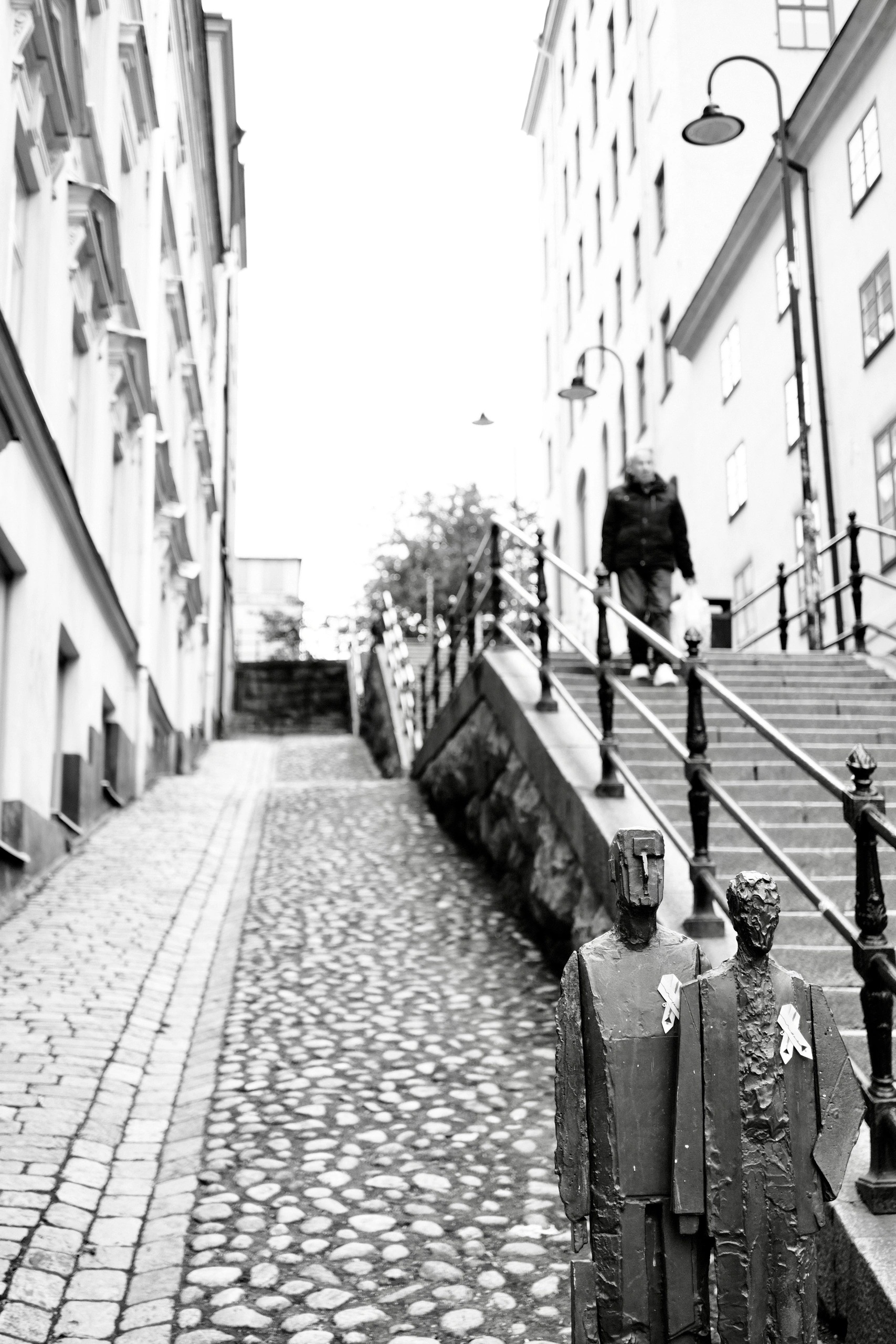 Cobblestone steps rising between Stockholm buildings