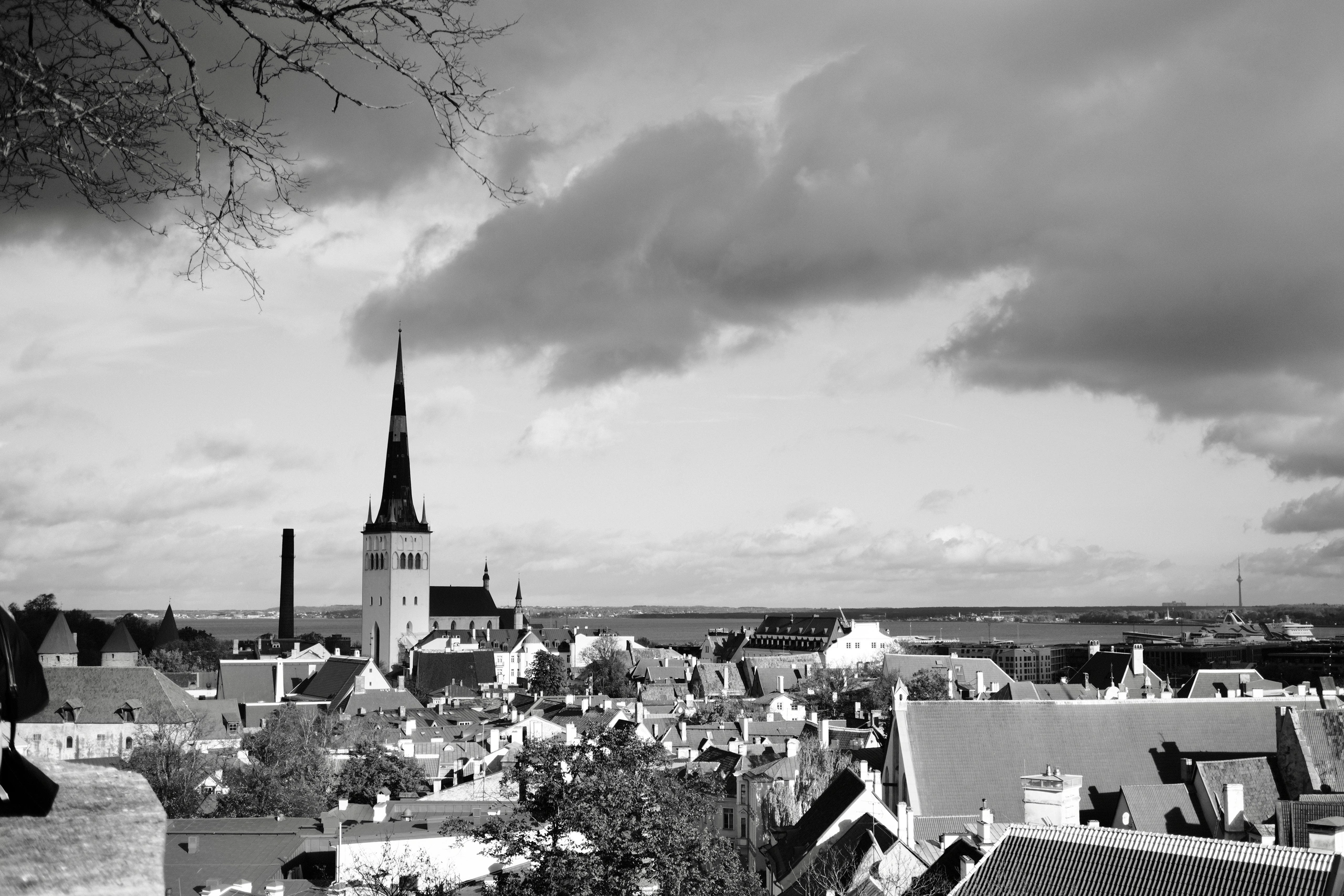 Church spire above Tallinn Old Town under dark clouds